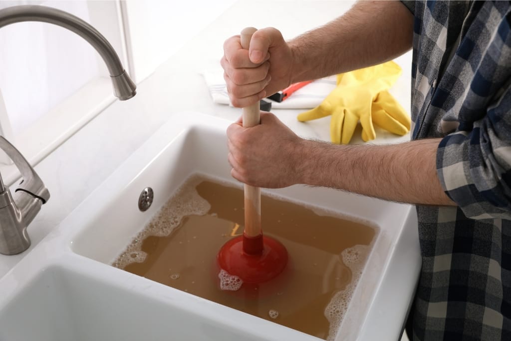 8 DIY Ways To Unclog A Kitchen Sink Without A Plumber